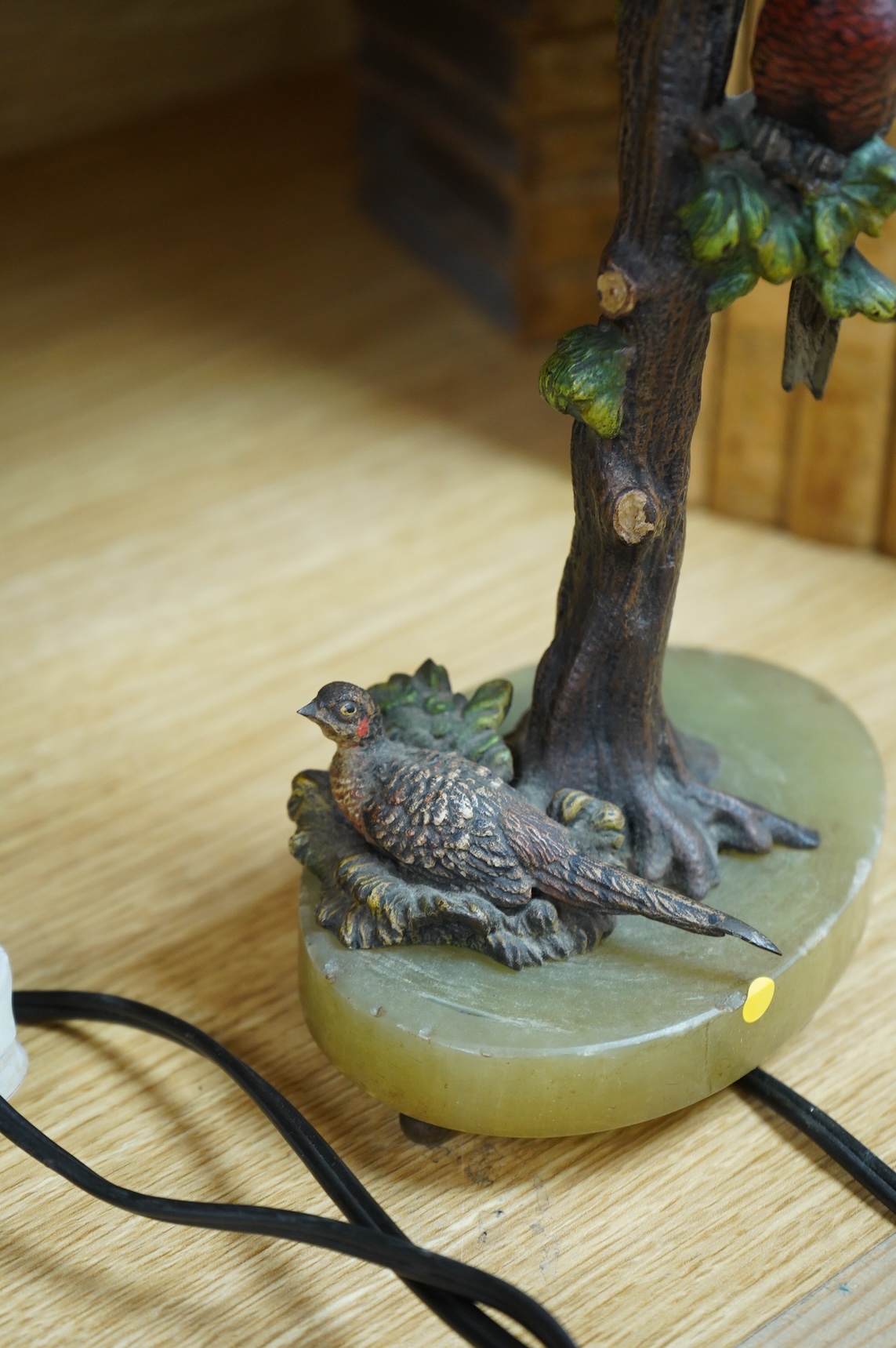 In the manner of Franz Xaver Bergmann (1861-1936), an Austrian cold painted bronze table lamp in the form a tree with pheasants, on green onyx oval base, unmarked, 34cm high including fitting